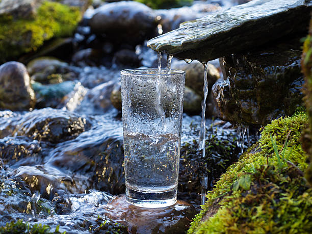 Home natural drinking water is being poured into glass